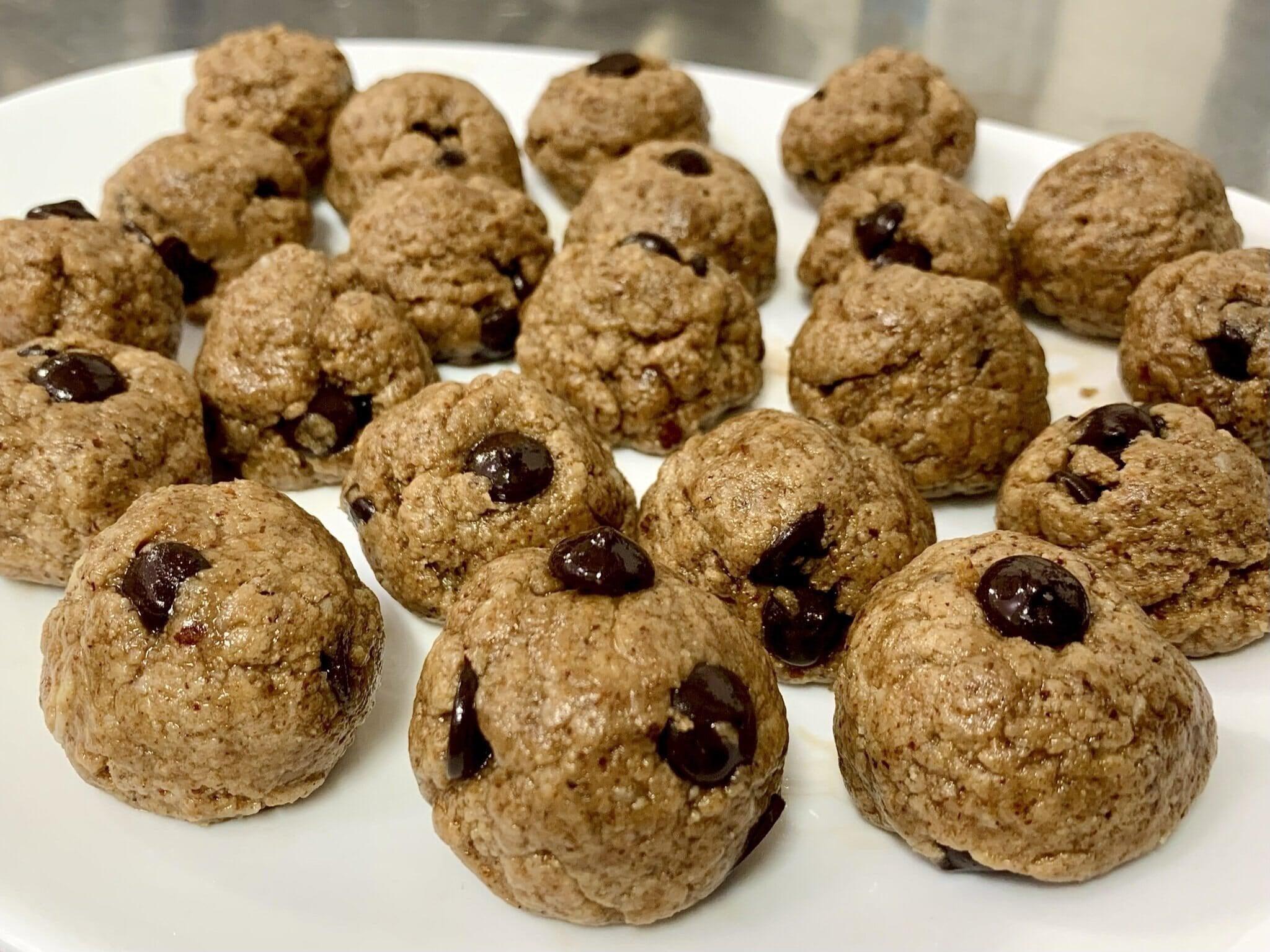 This is a picture of our Chocolate Chip Cookie Dough Protein Balls on a white table top.