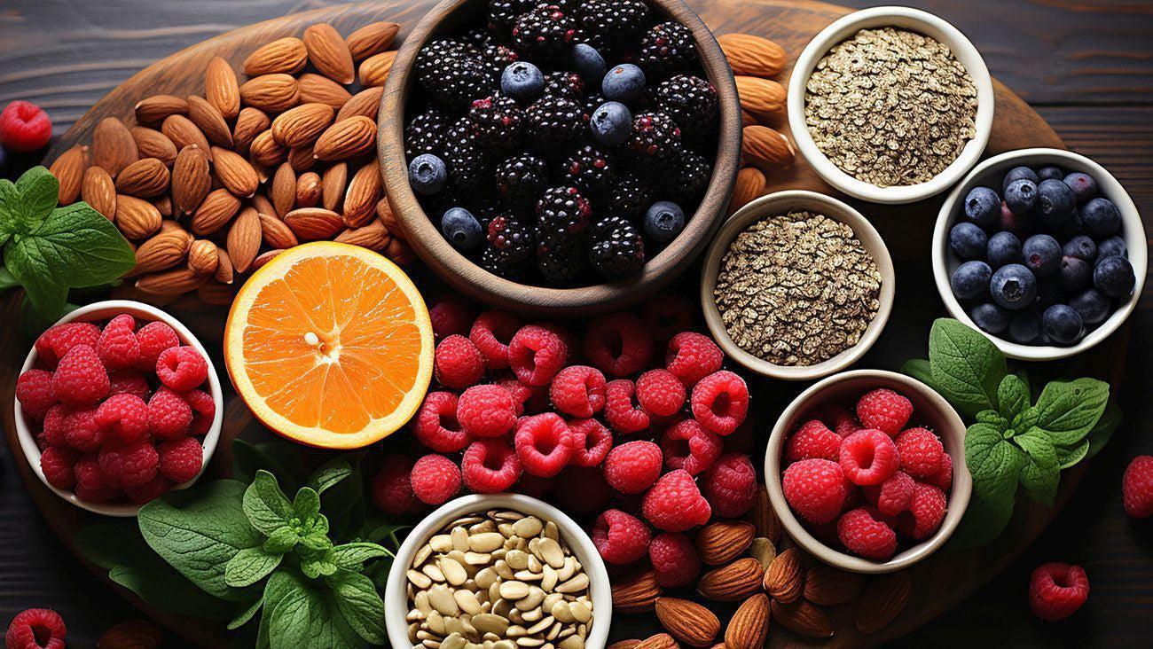 This is a picture of an assortment of whole, fresh foods on a wooden table background.