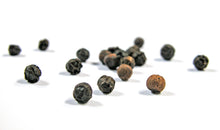 Photo of several black dried peppercorns