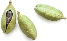Three Cardamom Seed pods on white background