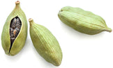 Three Cardamom Seed pods on white background