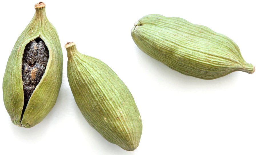 Three Cardamom Seed pods on white background