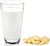 Image of glass of Cashew Milk with fresh cashew nuts next to glass