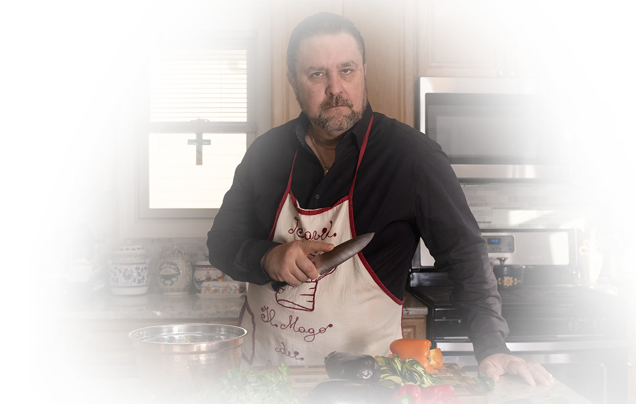 Image of a chef in a kitchen holding a sharp knife