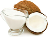 Image of half a coconut and coconut milk in a cup