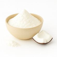 A bowl of white coconut powder with a coconut piece beside it on a white background.