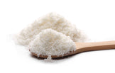 Closeup image Shredded coconut on a wooden spoon on a white background.