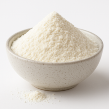 A bowl of organic freeze-dried coconut water powder in a neutral-colored bowl on a white background.