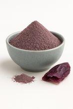 Organic dulse powder mounded in a plain neutral bowl on a white background, fine reddish-brown texture, evenly lit for true color.