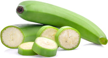 Photo of whole green unripe banana with slices of unripe banana
