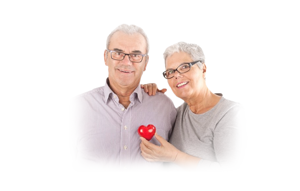 Image of smiling wife holding plastic red heart over husband's chest depicting a healthy heart.