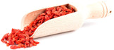Image of Sun Dried Goji Berries - Organic in wooden serving spoon on white background.