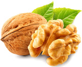 Closeup image of Walnut with walnut kernel behind it.