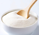 Whole Milk Powder  win white bowl with wooden spoon