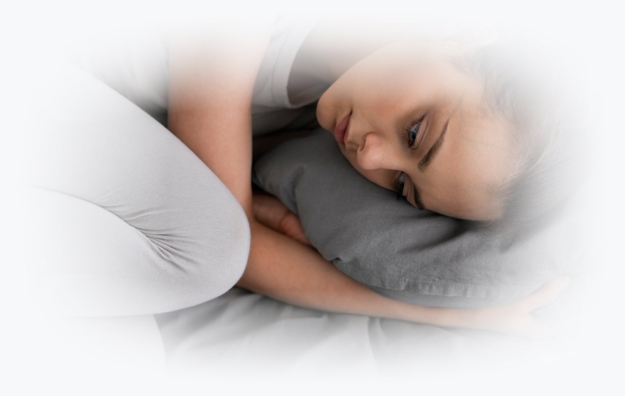 Image of a sad woman laying in bed feeling depressed