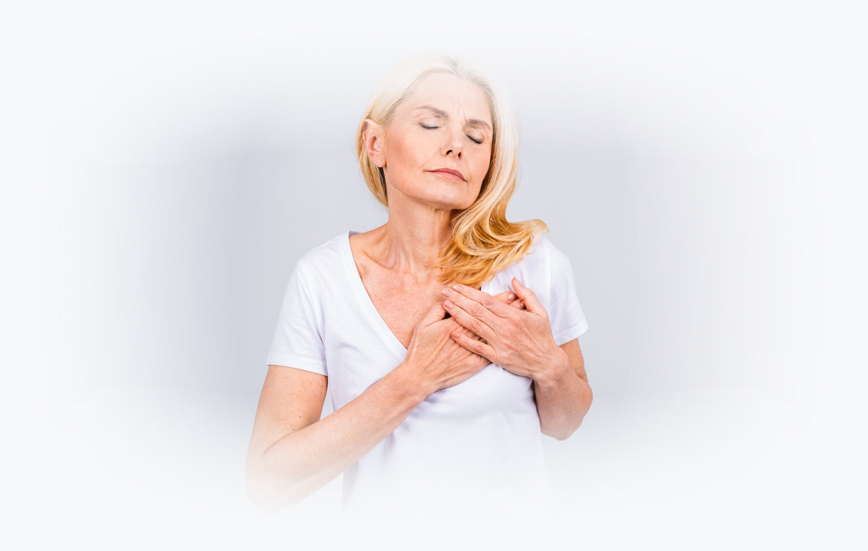 Image of woman holding her hands against her upper chest