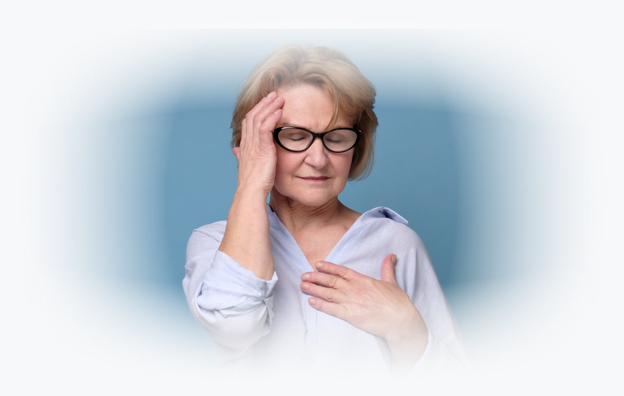 Photo of woman with eyes closed holding hand to head and feeling dizzy