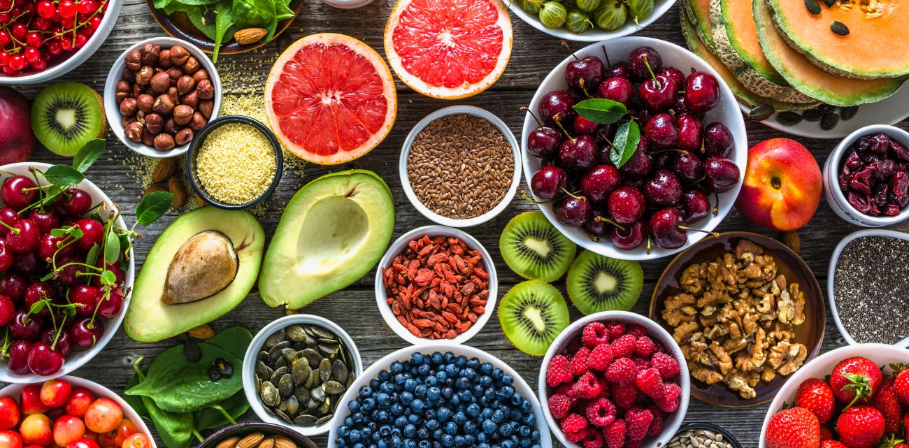 This is a picture of many super foods such as avocados, almonds, grapefruits, raspberries and much more