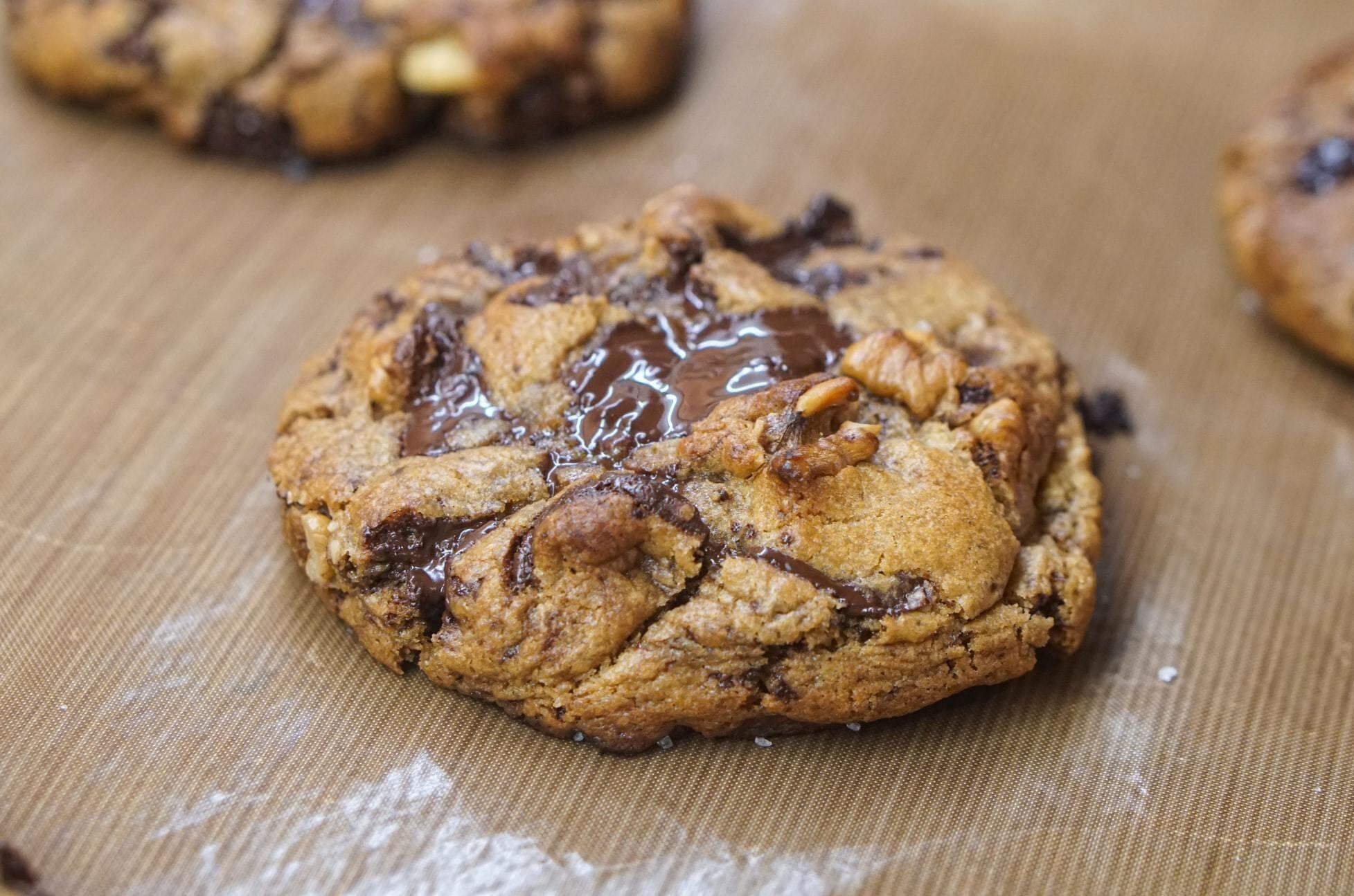 This is a picture of my delicious Vegan Chocolate CHip Cookies made with coconut flour on a wooden countertop.