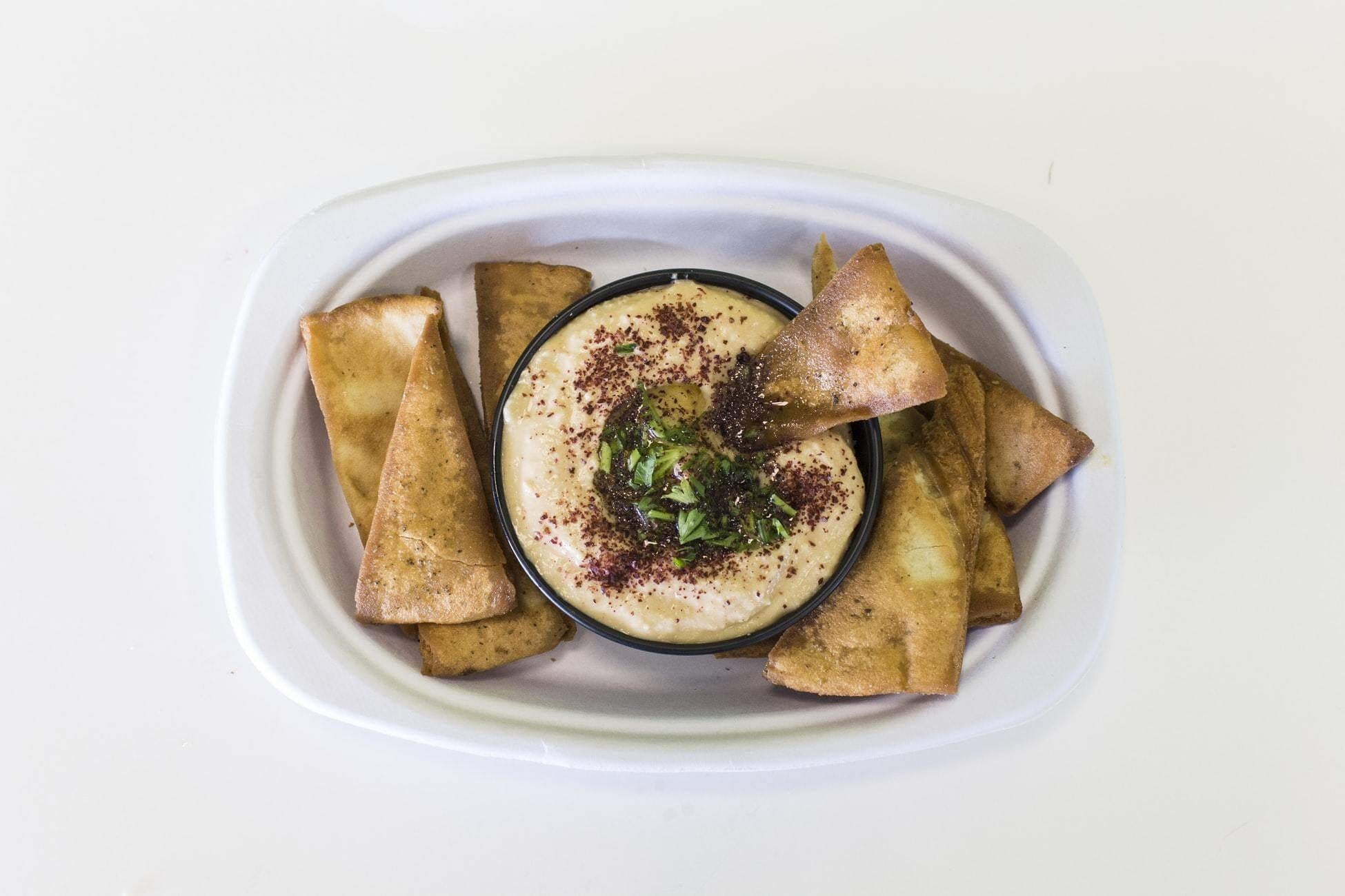 This is a link to our pumpkin dip in a white bowl with chips on a white background.