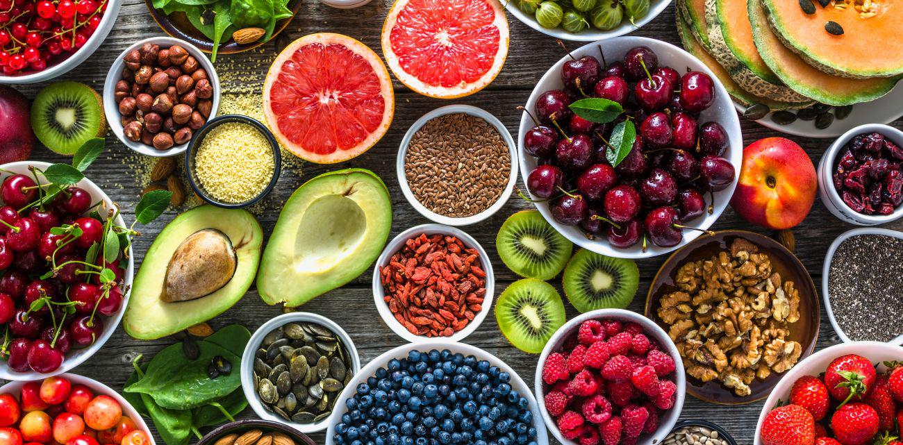 This is a picture of many super foods such as avocados, almonds, grapefruits, raspberries and much more