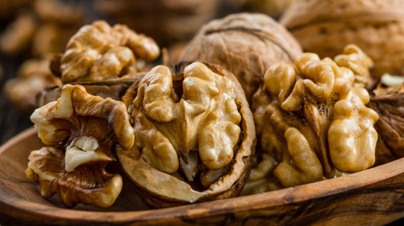 This is a picture of walnuts in a wooden bowl.