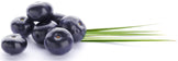 Image of multiple fresh acai berries and green leaves