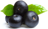 Image of multiple fresh acai berries and green leaves