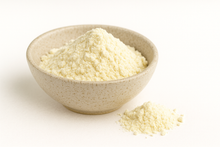 Bowl of buttermilk powder on white background