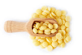 Image of Cacao Butter Wafers and a wooden scoop