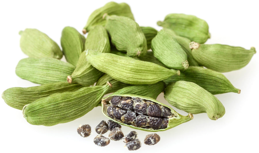 Image of several green Cardamom Seed pods with one pod in front peeled back to exposing the seeds inside.