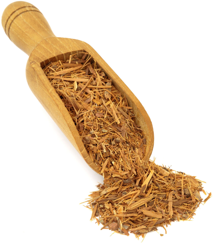 Image of brown Catuaba Bark shreds and a wooden scoop