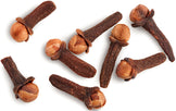 Cloves piled together on white background