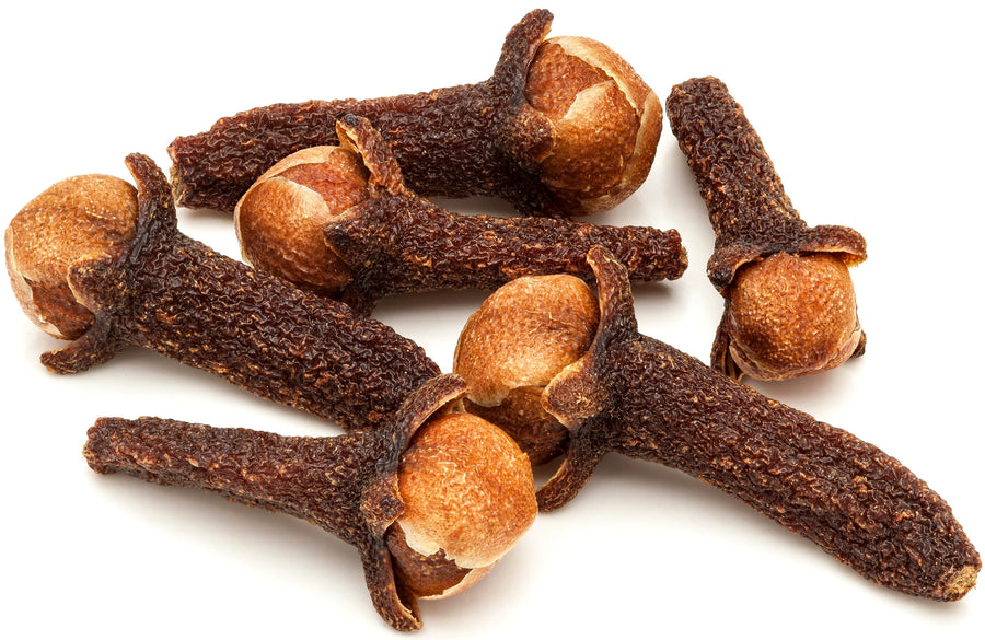 Cloves piled together on white background