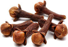 Cloves piled together on white background