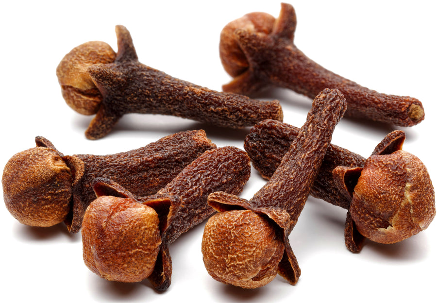 Cloves piled together on white background