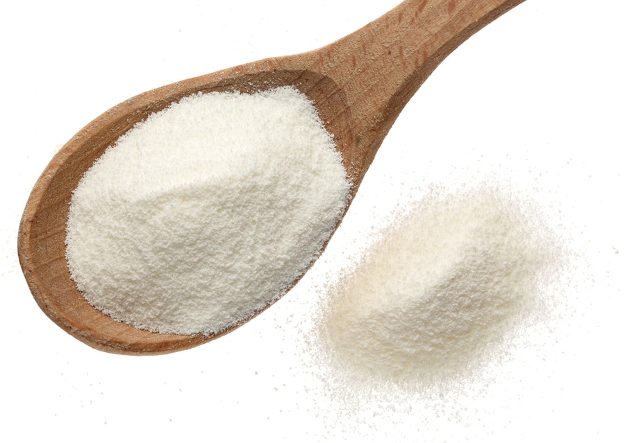 Image of Vanilla Collagen creamer powder on a wooden spoon