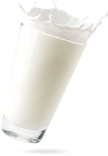 Glass of Goat Milk spilling 