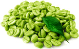 Closeup image of halved Green Coffee Beans in pile with one leaf on top.
