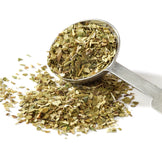 Image of loose Green Tea leaves in stainless steel measuring spoon.