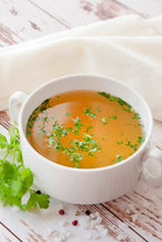 Image of Instant Bone Broth Soup Base Powder mixed with water in a white mug