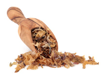 Irish Moss piled together with wooden scoop on white background