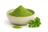 Bowl of organic kale powder with a fresh kale leaf beside it on a white background