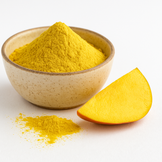 A bowl of organic mango juice powder with a small pile of powder in front and a fresh mango slice beside it on a white background