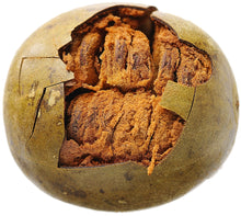 Image of a brown Luo Han Guo fruit cut in half showing its brown inside pulp