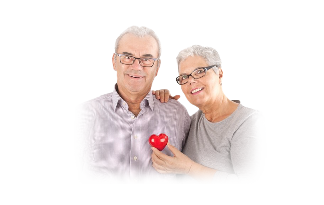 Image of smiling wife holding plastic red heart over husband's chest depicting a healthy heart. 