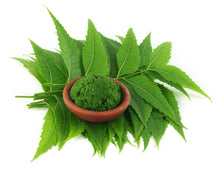 Image of Neem Leaves under a brown bowl full of neem leaf paste