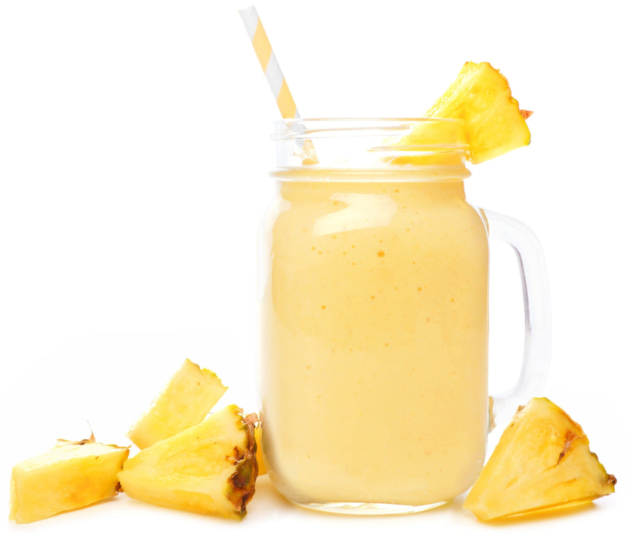 Photo of glass of Organic Electrolyte Pineapple Coconut Water Sports & Energy Drink with slices of fresh pineapple 
