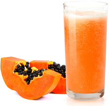 Glass of Papaya Juice in front of two papaya slices on white background.