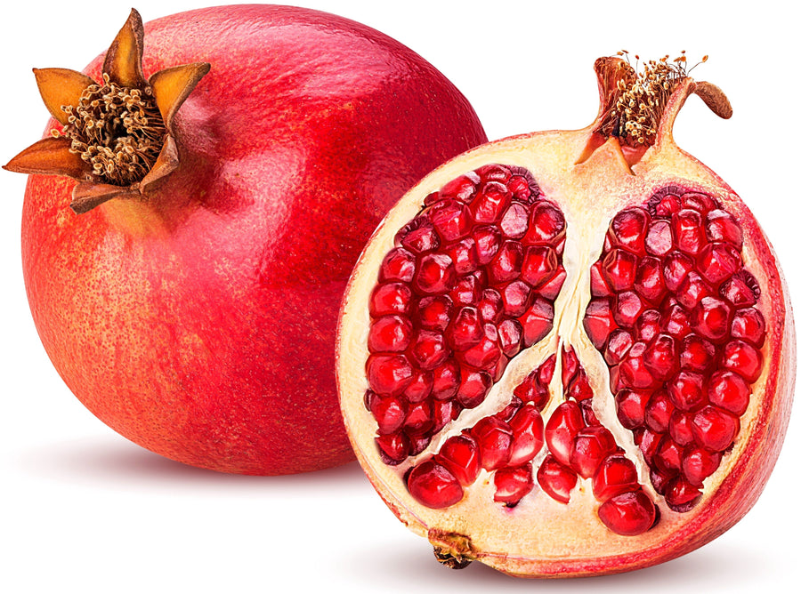 Image of a fresh Pomegranate and half of one showing its bright red seeds